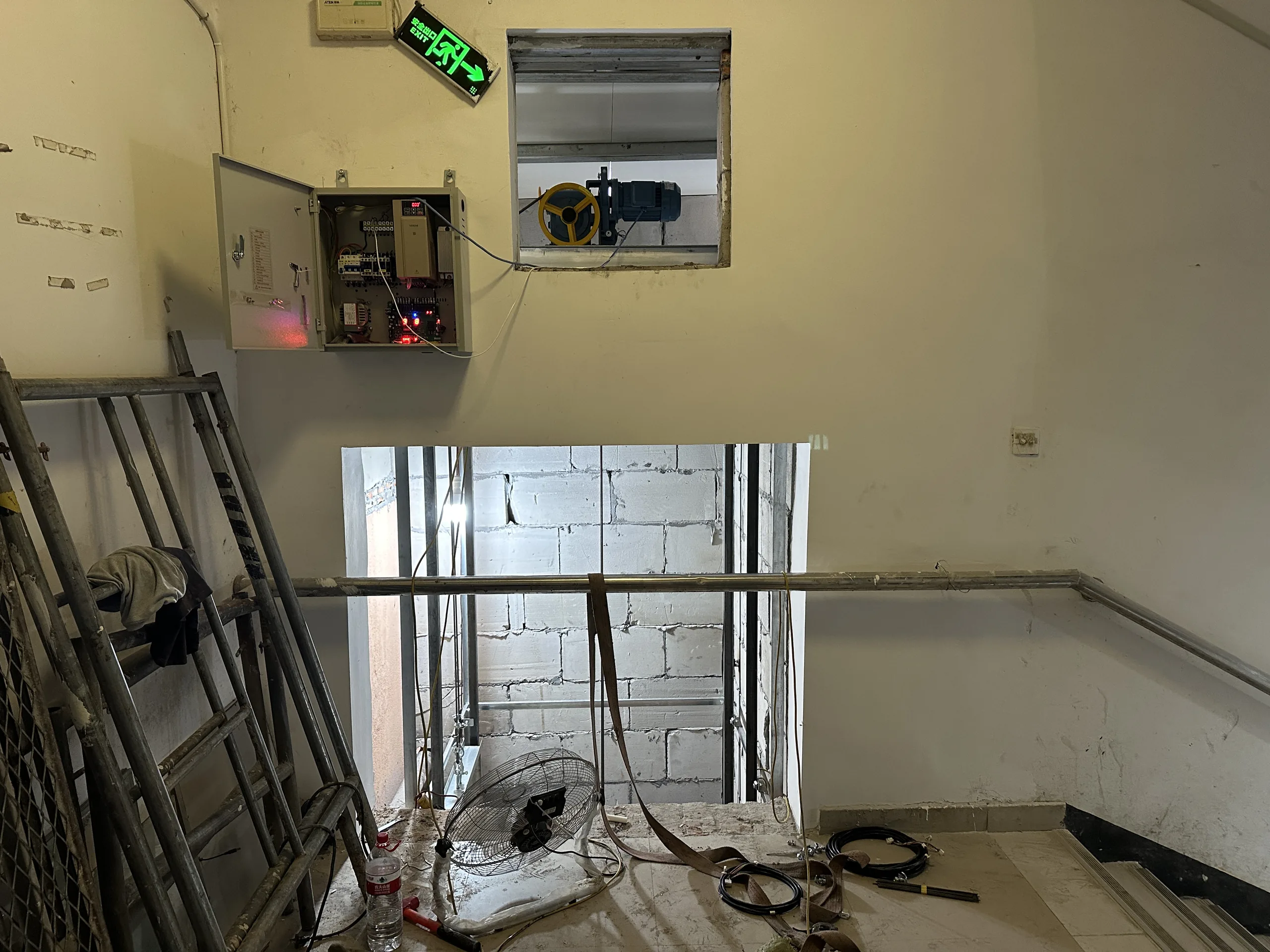 Dumbwaiter inspection of a control panel and landing opening during a site visit