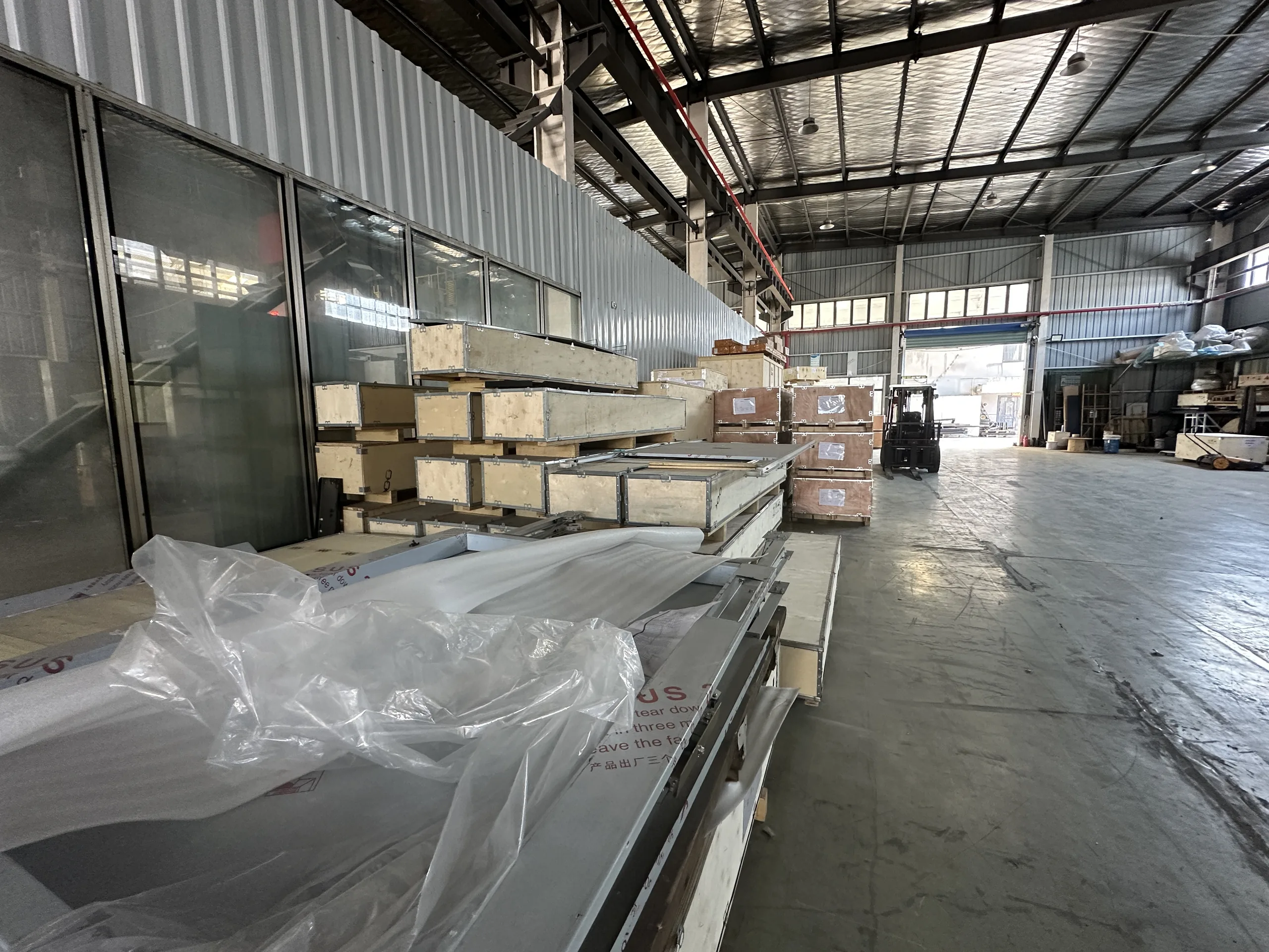 Packed food elevator units and panels ready for shipment in the ServLifts warehouse