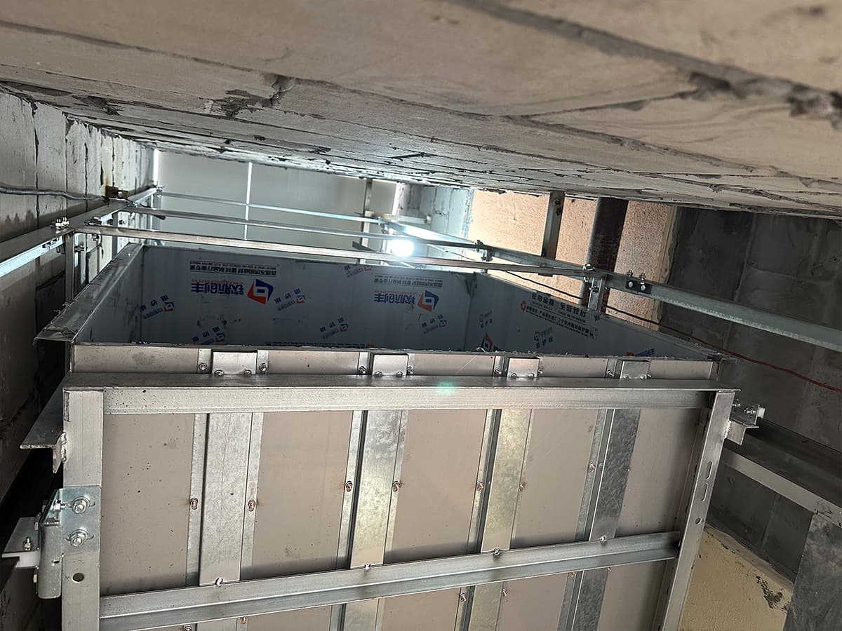 Dumbwaiter car frame assembled inside the shaft during installation, guide rails already fixed